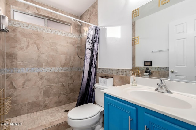 bathroom featuring walk in shower, vanity, toilet, and tile walls