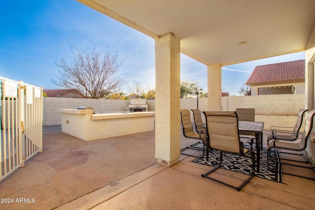 view of patio / terrace featuring exterior kitchen and an outdoor bar