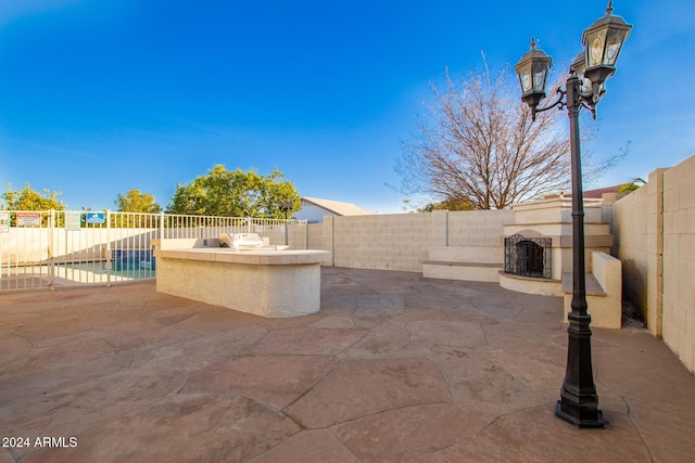 view of patio / terrace with a fenced in pool and exterior kitchen