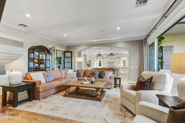 living room with crown molding and wood-type flooring