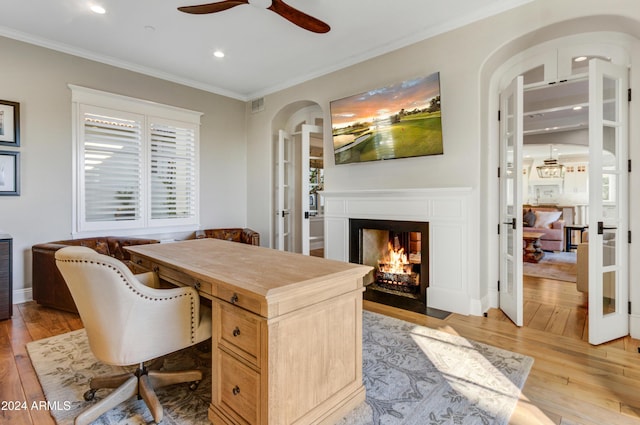 office space featuring crown molding, french doors, ceiling fan, and light hardwood / wood-style floors