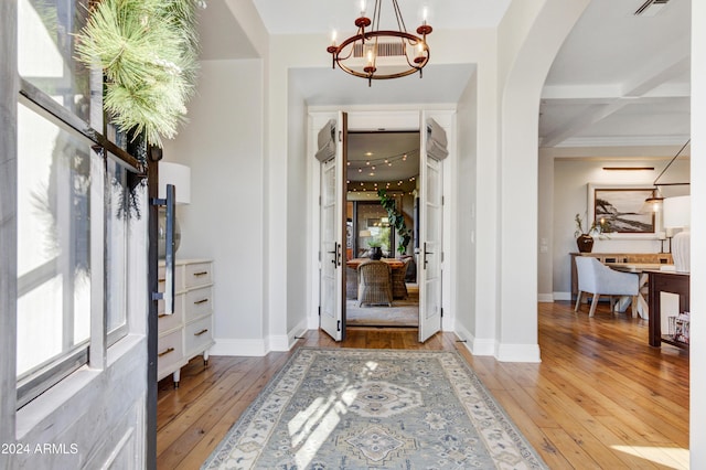 10191 E Diamond Rim Dr Unit 2122, Scottsdale, AZ 85255 - entryway with a chandelier, hardwood / wood-style flooring, arched walkways, baseboards, and beam ceiling