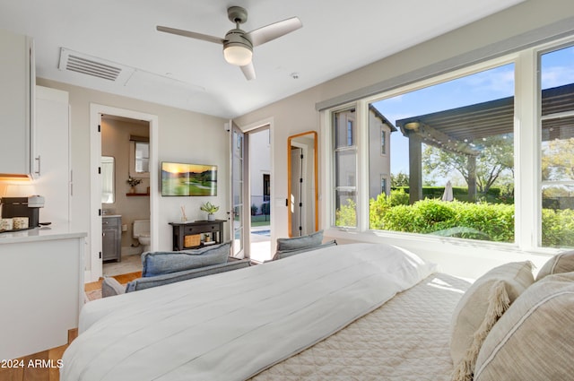 bedroom with ensuite bathroom, ceiling fan, and light hardwood / wood-style floors