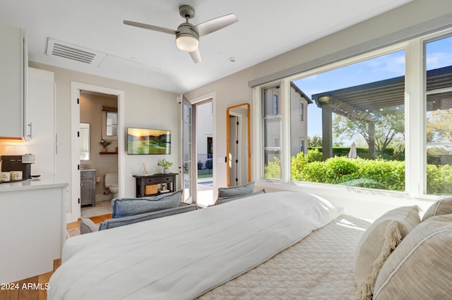 10191 E Diamond Rim Dr Unit 2122, Scottsdale, AZ 85255 - bedroom featuring multiple windows, light wood-type flooring, a wood stove, and ceiling fan