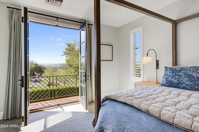 carpeted bedroom with access to outside