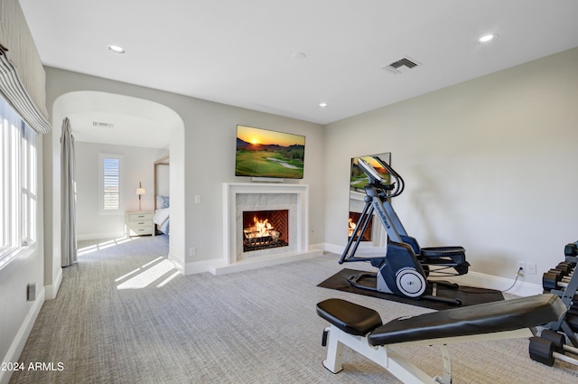 10191 E Diamond Rim Dr Unit 2122, Scottsdale, AZ 85255 - workout room with arched walkways, a premium fireplace, carpet flooring, baseboards, and recessed lighting