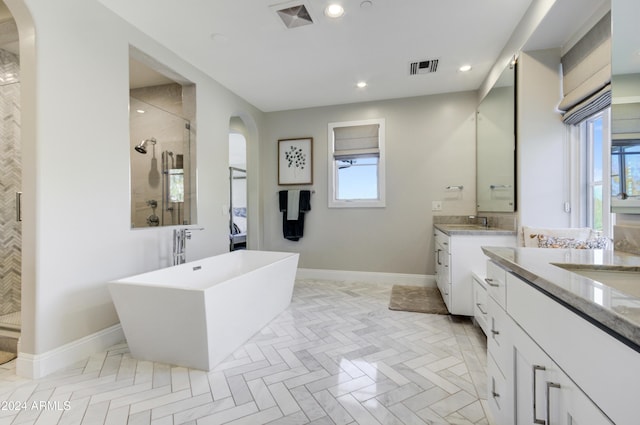 10191 E Diamond Rim Dr Unit 2122, Scottsdale, AZ 85255 - full bath with a stall shower, two vanities, a freestanding tub, recessed lighting, and baseboards