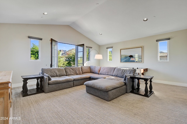 living room with light carpet and vaulted ceiling