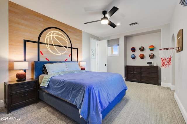 bedroom featuring wood walls and ceiling fan