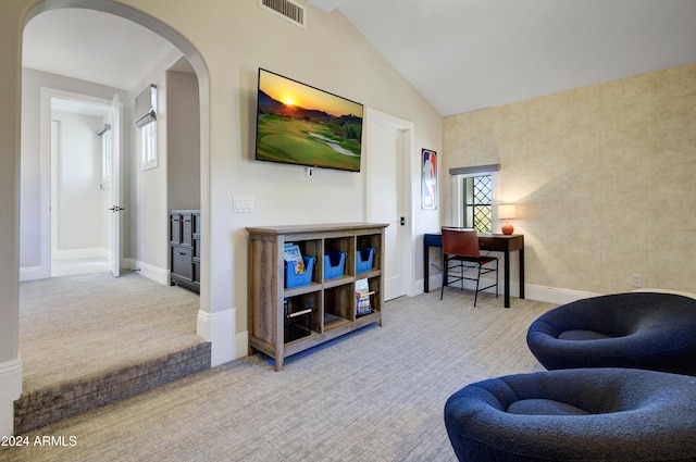 living area with light colored carpet and lofted ceiling