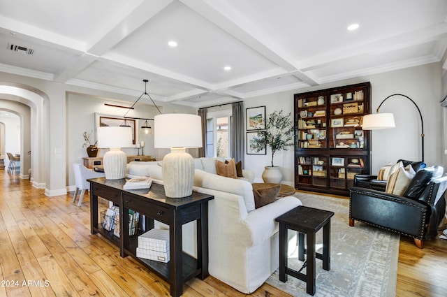 living room with beam ceiling, light hardwood / wood-style flooring, coffered ceiling, and crown molding