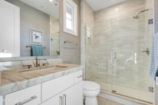 bathroom featuring tile patterned floors, vanity, an enclosed shower, and toilet