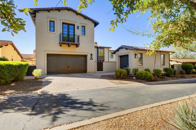 10191 E Diamond Rim Dr Unit 2122, Scottsdale, AZ 85255 - mediterranean / spanish home featuring stucco siding, an attached garage, a balcony, and decorative driveway