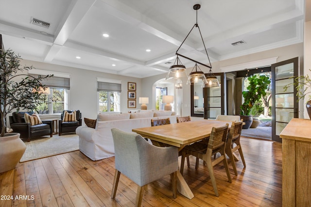 dining area with beamed ceiling, coffered ceiling, and hardwood / wood-style flooring