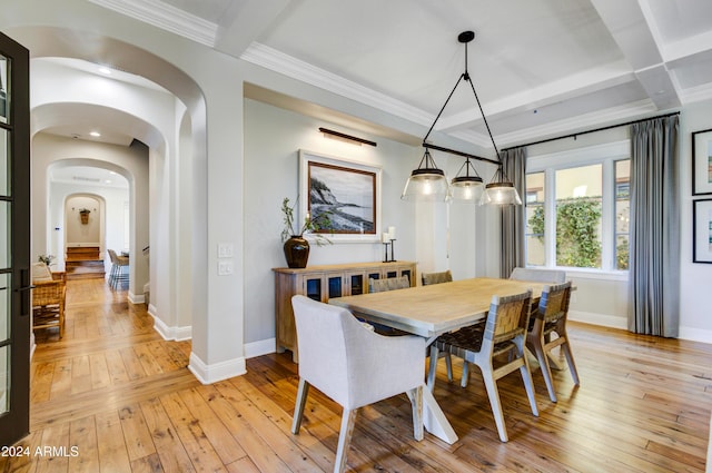 dining space with beamed ceiling, light hardwood / wood-style floors, and ornamental molding