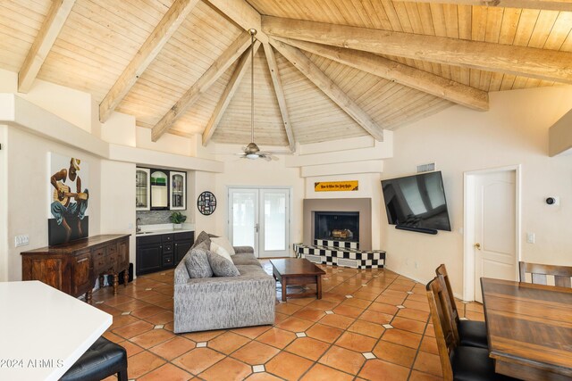 living room featuring beam ceiling, wood ceiling, and high vaulted ceiling