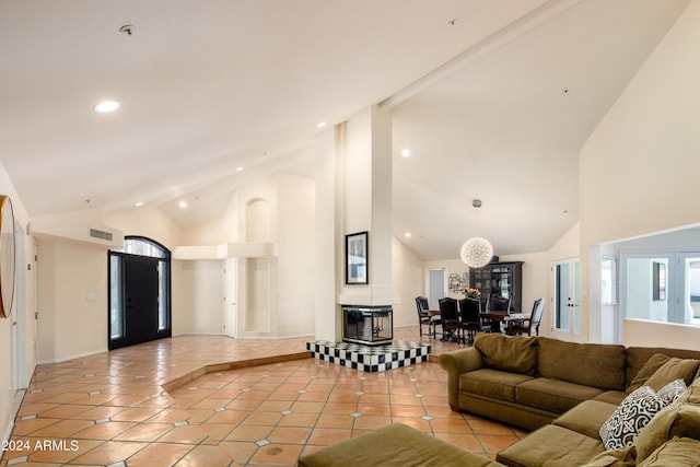 tiled living room with high vaulted ceiling and a wealth of natural light