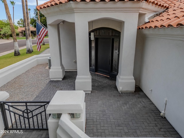 view of exterior entry featuring covered porch