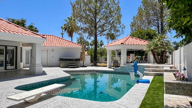 view of pool featuring a gazebo, a patio area, a diving board, and a hot tub