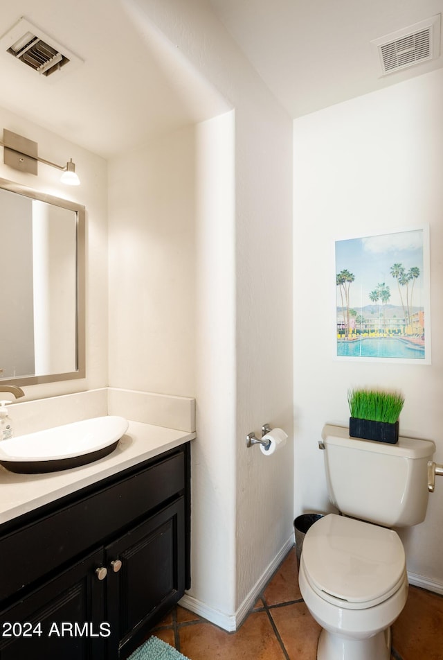 bathroom with tile patterned floors, vanity, and toilet