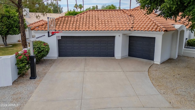 mediterranean / spanish home featuring a garage