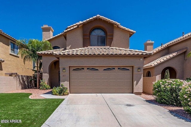 mediterranean / spanish home featuring a garage