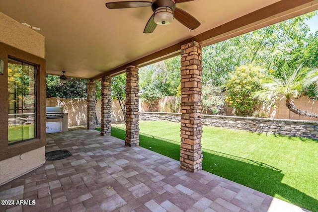 view of patio with area for grilling and ceiling fan