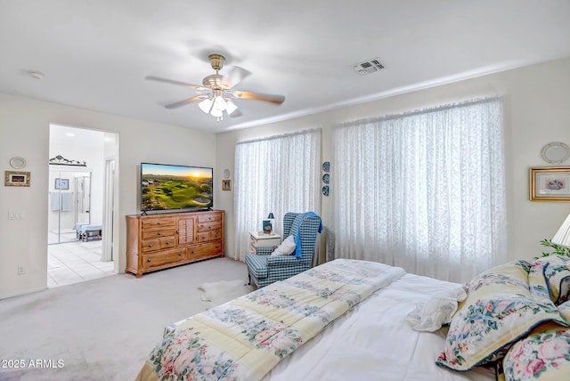 3336 W King Dr, Anthem, AZ 85086 - bedroom with carpet floors, multiple windows, connected bathroom, and ceiling fan
