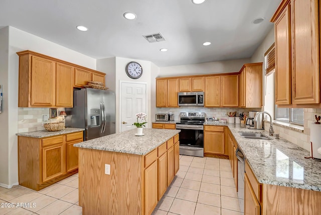 3336 W King Dr, Anthem, AZ 85086 - kitchen featuring appliances with stainless steel finishes, a sink, tasteful backsplash, a kitchen island, and recessed lighting