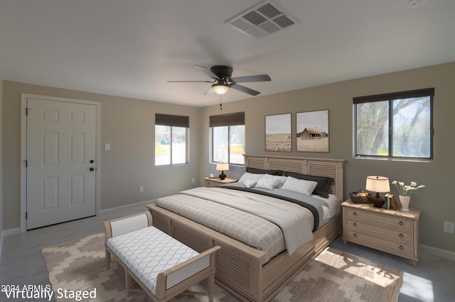 bedroom featuring multiple windows and ceiling fan