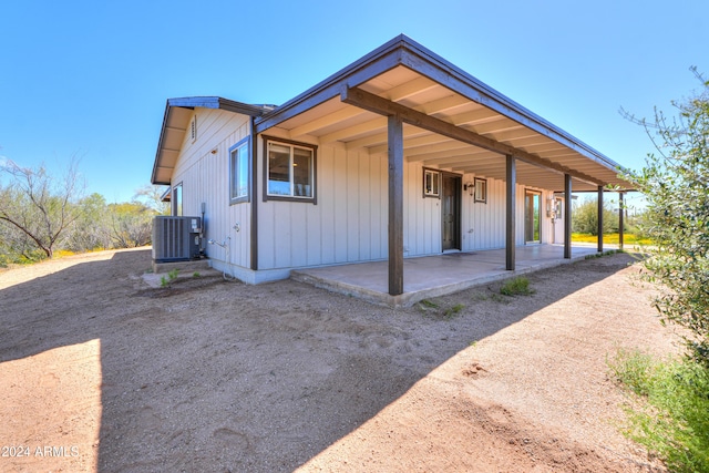 view of front of home featuring central air condition unit and a patio