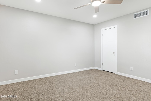 empty room featuring carpet, visible vents, ceiling fan, and baseboards