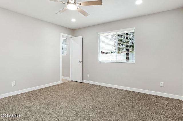 empty room featuring light carpet, recessed lighting, a ceiling fan, and baseboards