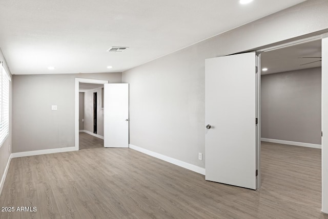 unfurnished bedroom with baseboards, visible vents, and wood finished floors