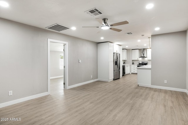 unfurnished living room with light wood-type flooring, baseboards, and visible vents