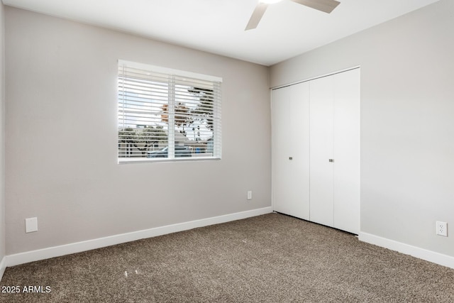 unfurnished bedroom featuring carpet floors, a closet, and baseboards