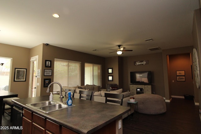 kitchen with a healthy amount of sunlight, sink, dark hardwood / wood-style flooring, and dishwasher