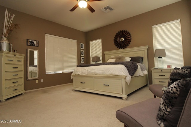 bedroom featuring light colored carpet and ceiling fan