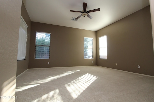 unfurnished room with ceiling fan and light carpet