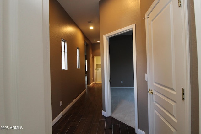 corridor with dark hardwood / wood-style floors and washer / dryer