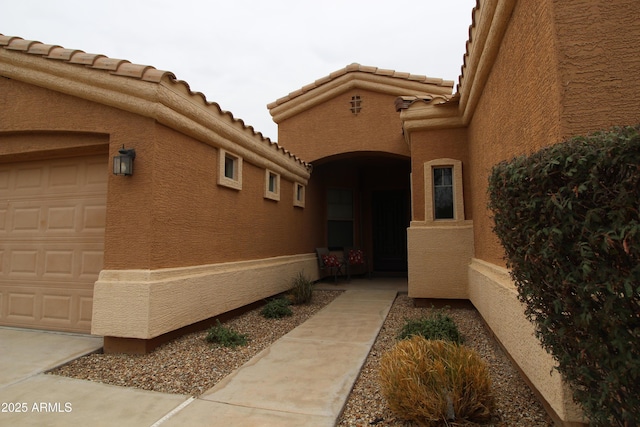 view of exterior entry with a garage