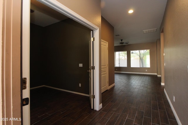 corridor with dark hardwood / wood-style flooring