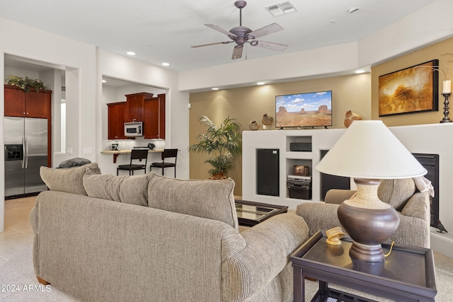 tiled living room featuring ceiling fan