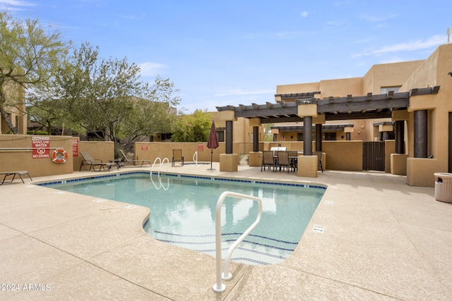 view of swimming pool featuring a pergola and a patio area