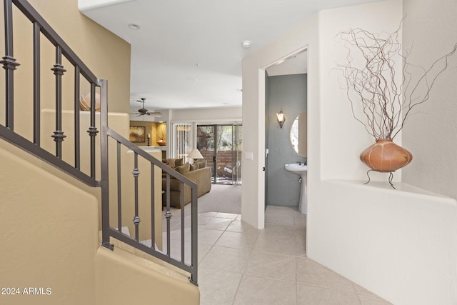 stairs with tile patterned flooring and ceiling fan