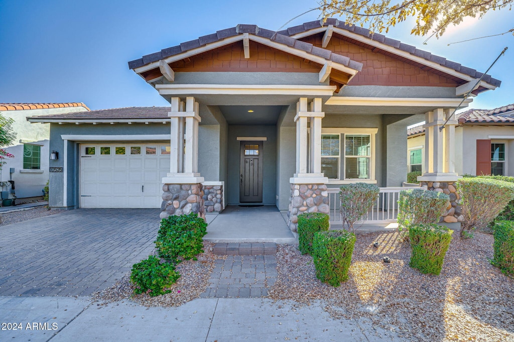 craftsman-style house with a garage and covered porch