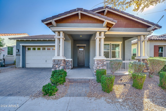 craftsman-style house with a garage and covered porch