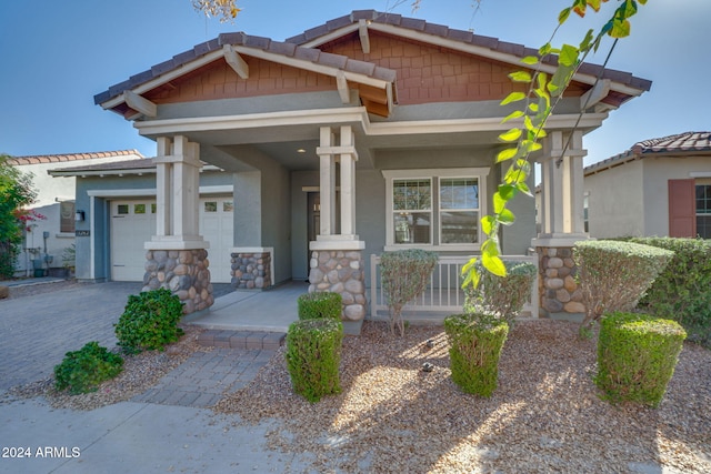 craftsman-style house featuring a garage and covered porch