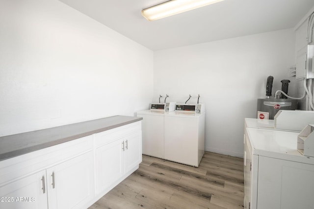 5623 W Myrtle Ave, Glendale, AZ 85301 - laundry room with cabinet space, baseboards, light wood-style flooring, water heater, and separate washer and dryer