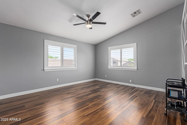 unfurnished living room with healthy amount of natural light, ceiling fan, lofted ceiling, dark wood-style flooring, and baseboards